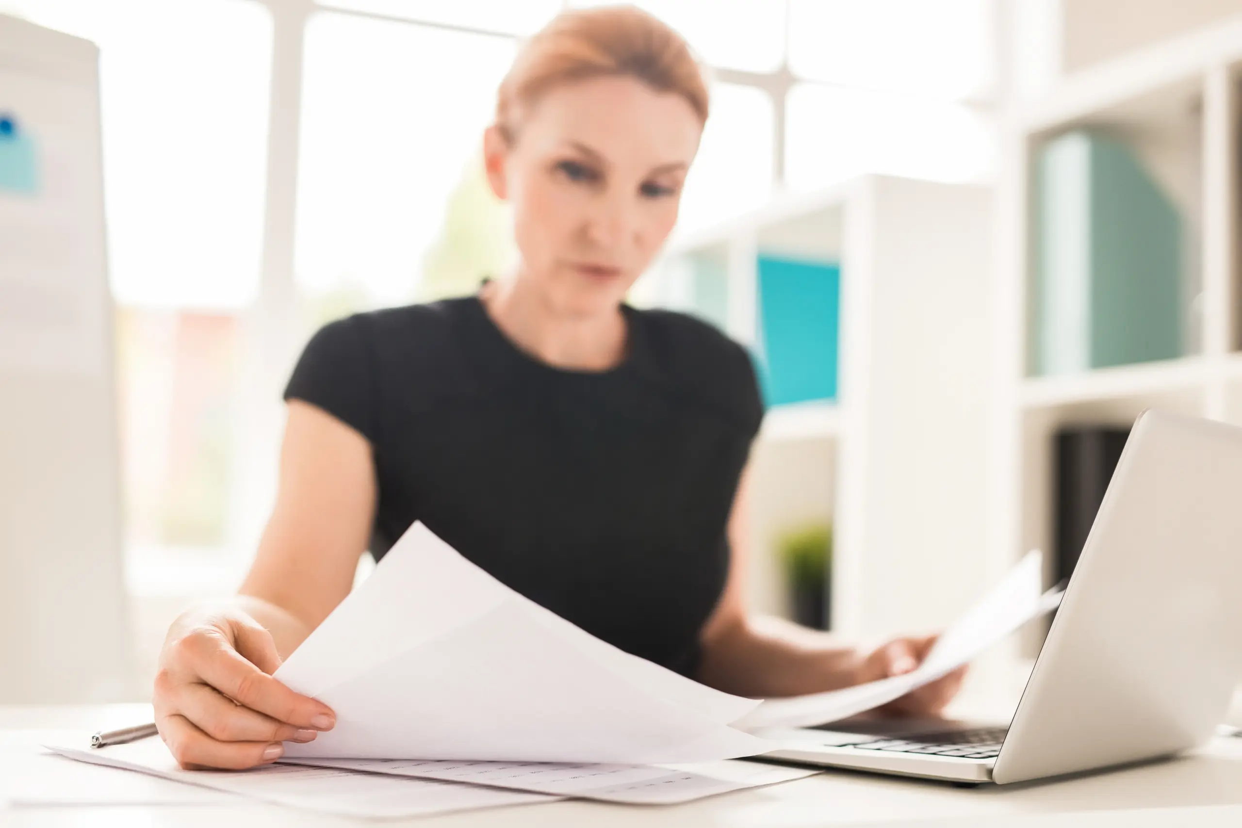 Homeowner reviewing mortgage paperwork before remortgaging early.