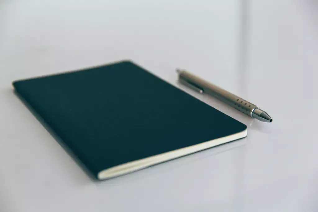 Notebook and pen used to prepare remortgage solicitor questions.
