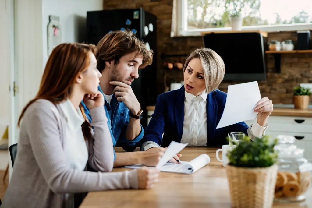 Couple discussing their mortgage circumstances with a financial adviser.
