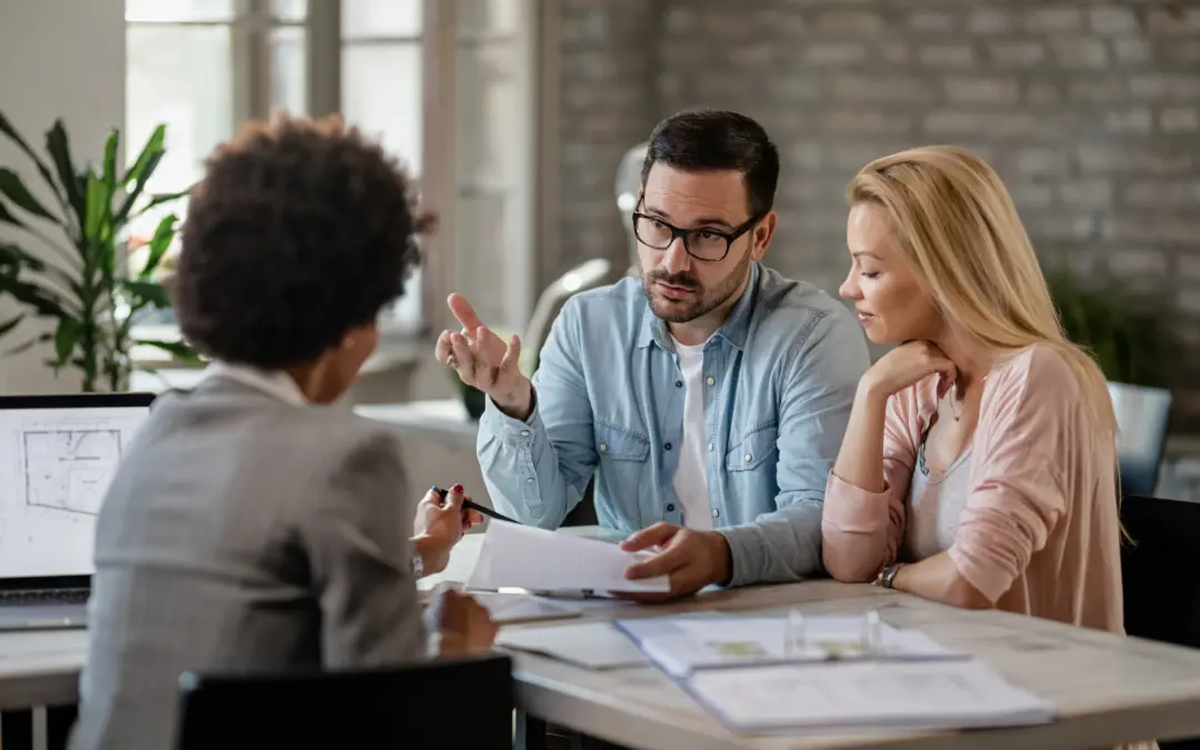 Couple discussing mortgage options with a financial adviser.