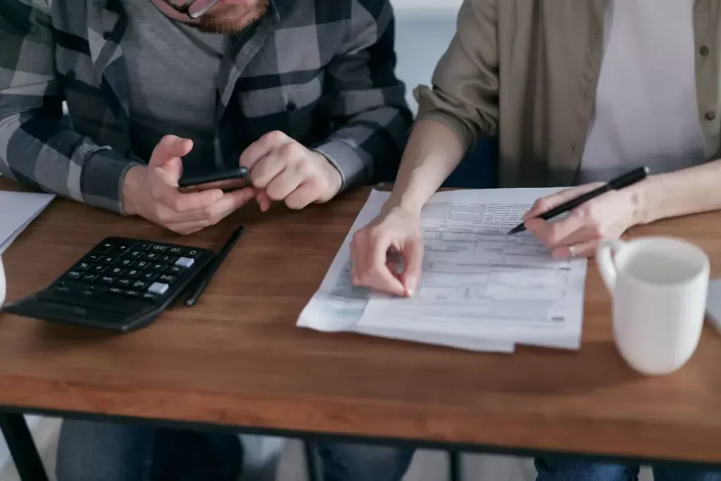 Couple reviewing financial commitments before applying for a mortgage.