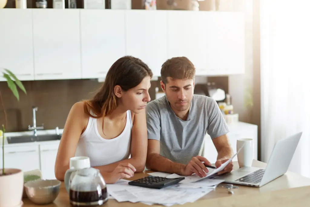 Couple reviewing household finances and mortgage affordability at home.
