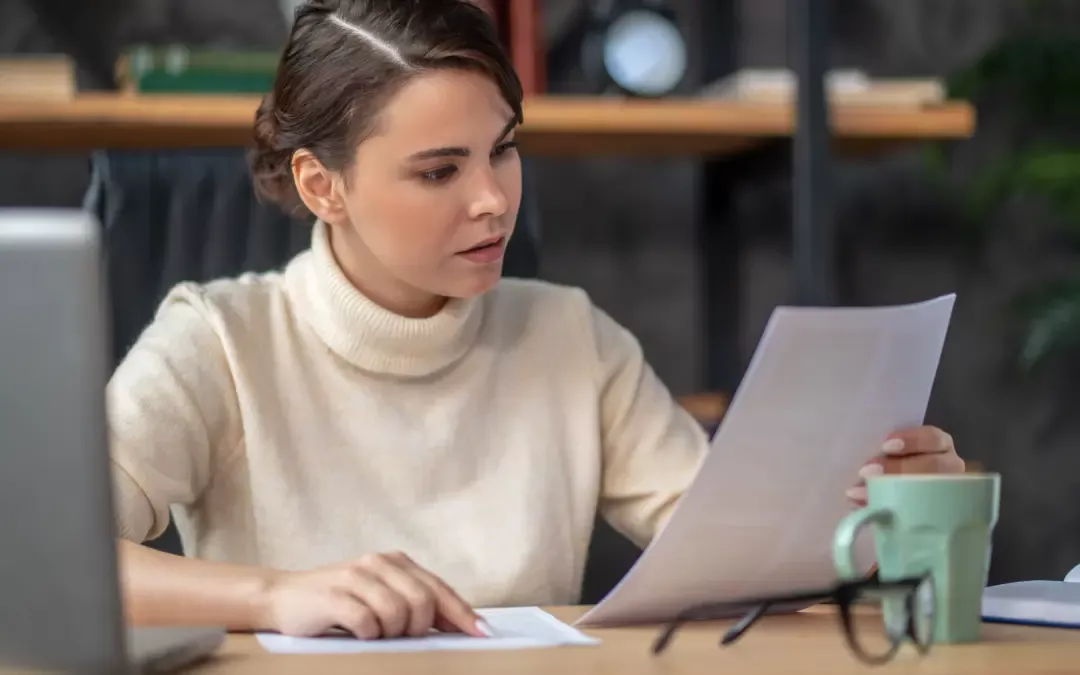 Woman reviewing financial documents before a mortgage application.