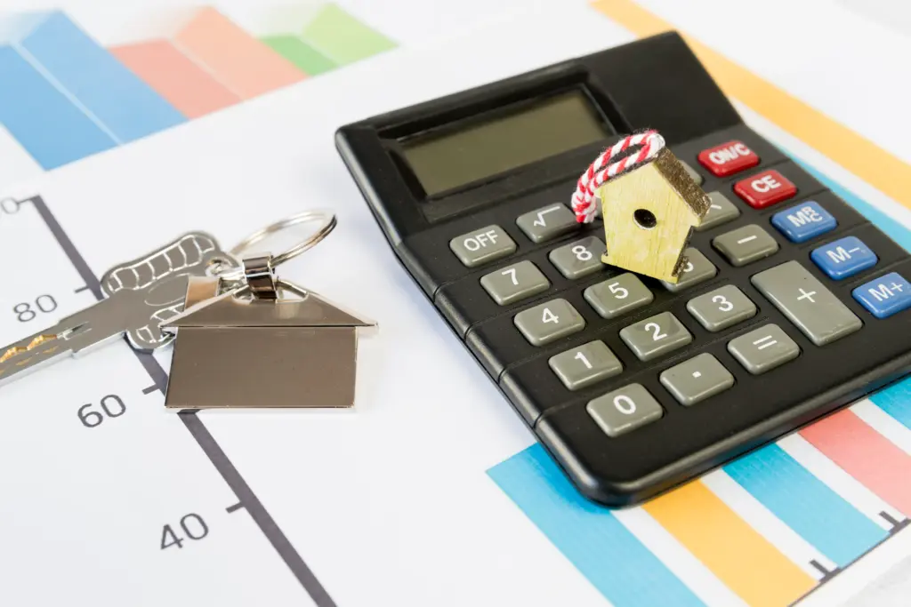 House key and calculator representing mortgage and income planning.
